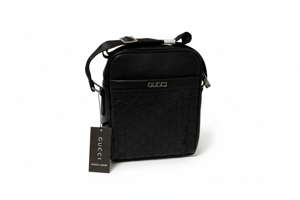 Black Gucci bag with a tag on a white surface