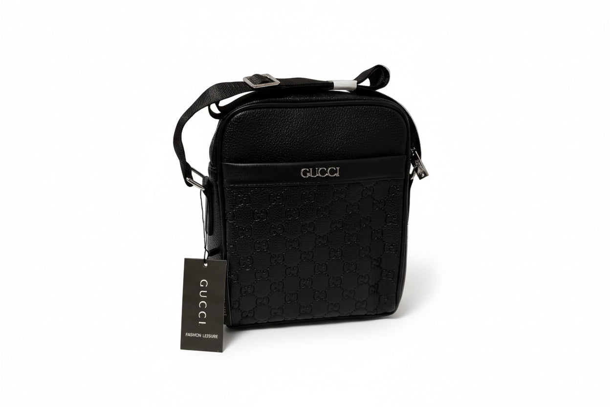 Black Gucci bag with a tag on a white surface